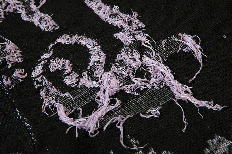 Close-up of unique glitch style graphics on premium acrylic sweater designed for underground rave scene