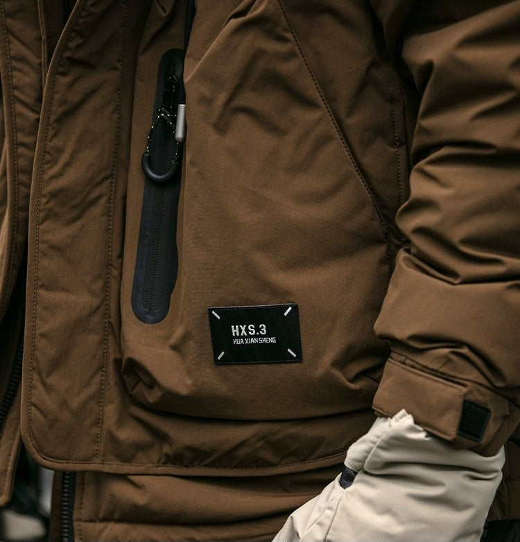 Oversized corduroy hooded down jacket in black and brown colorways with multi-pocket design